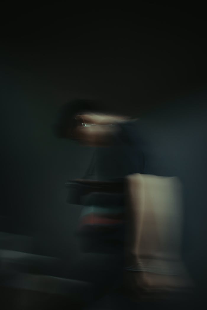 Blurred artistic image capturing the motion and mystery of an unrecognizable figure.